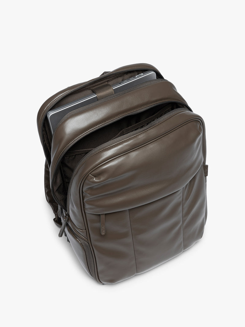 laptop sleeve of CALPAK Mushroom brown Luka 15 inch Laptop Backpack in vegan leather with a glossy finish, featuring a top carry handle, a main zippered compartment, and a front slip pocket, shown against a plain white background