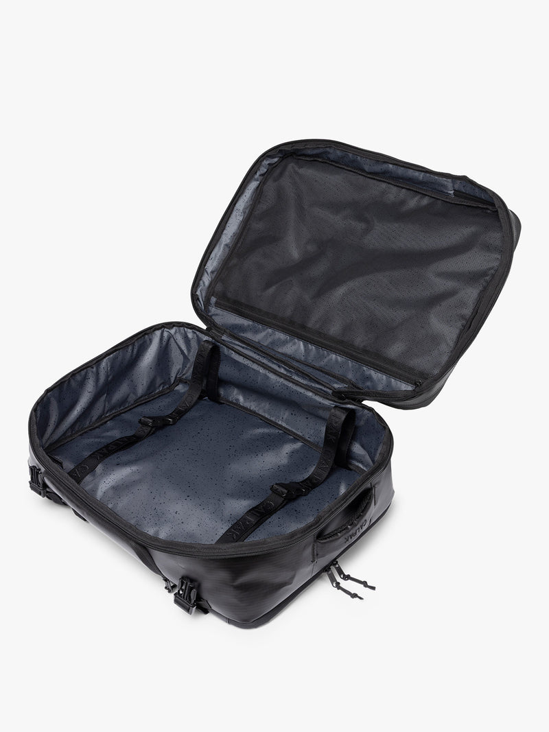 Opened CALPAK Terra 35L Laptop Backpack Duffel in matte black Obsidian on a white background