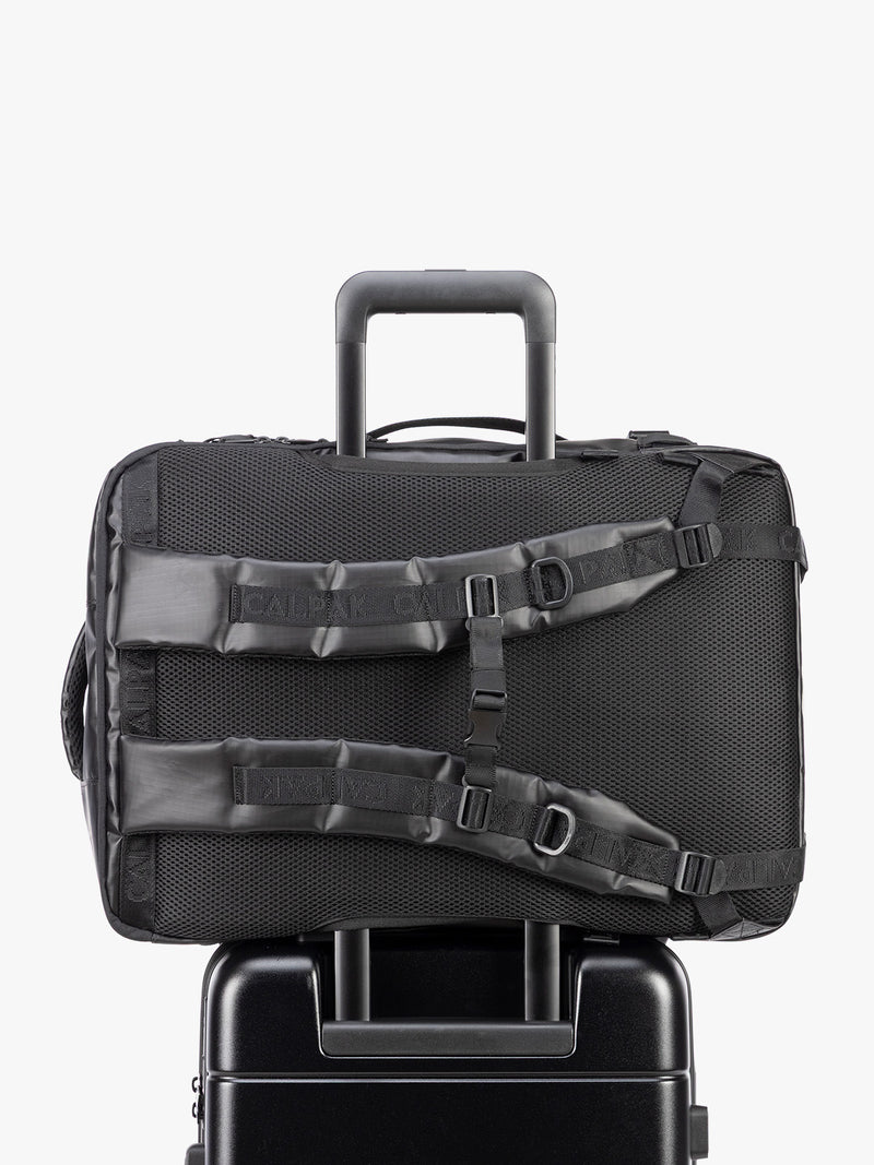 Back trolley sleeve of CALPAK Terra 35L Laptop Backpack Duffel in matte black Obsidian on a white background