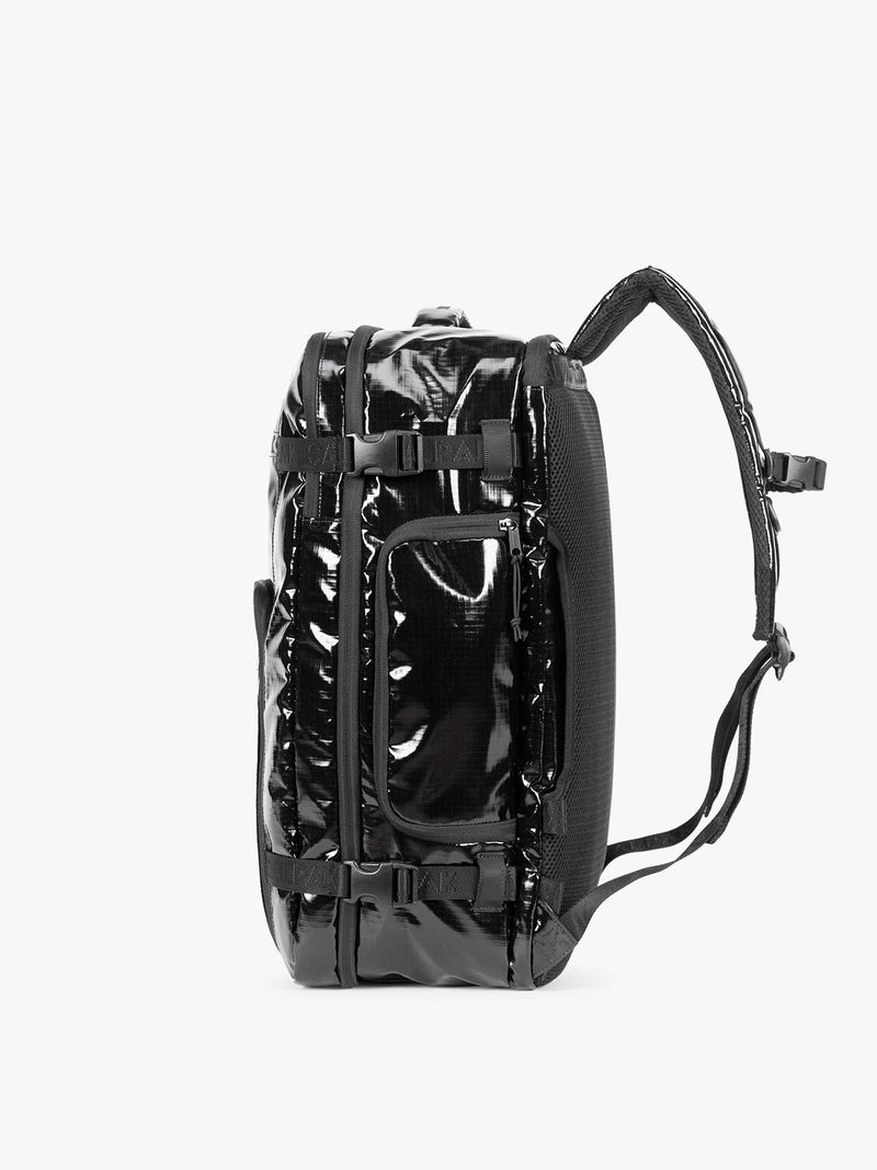 Side view of  the CALPAK Terra 35L Laptop Duffel Backpack in shiny black Obsidian on a white background