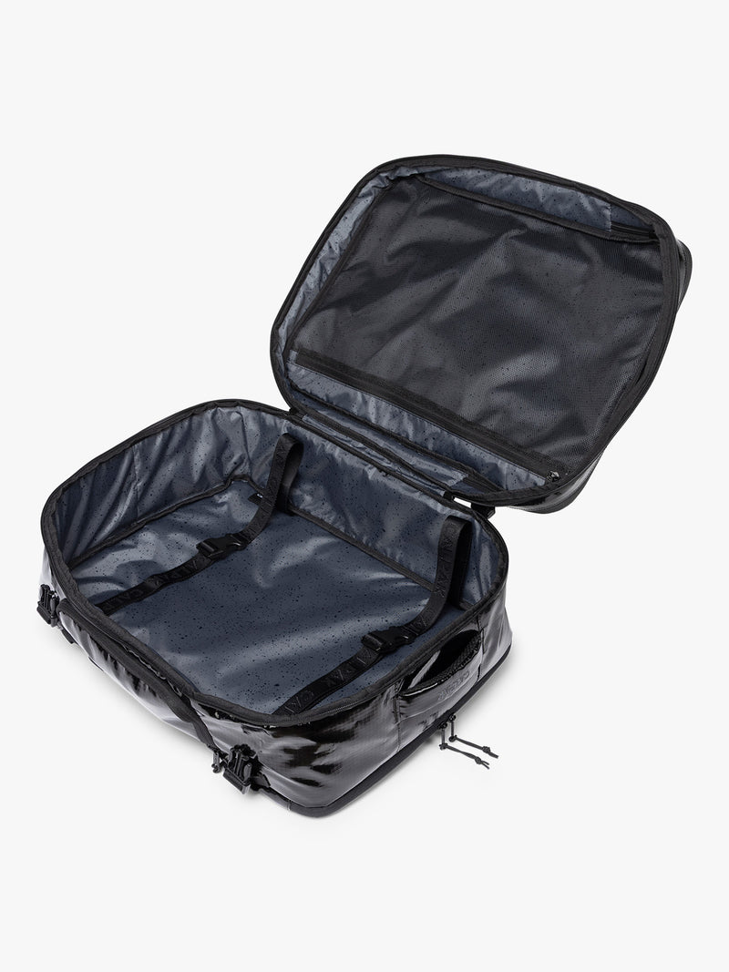 Opened  CALPAK Terra 35L Laptop Duffel Backpack in shiny black Obsidian on a white background