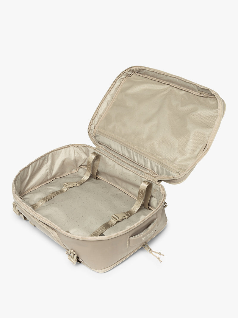Opened CALPAK Terra 35L Laptop Backpack Duffel in beige Stone on a white background