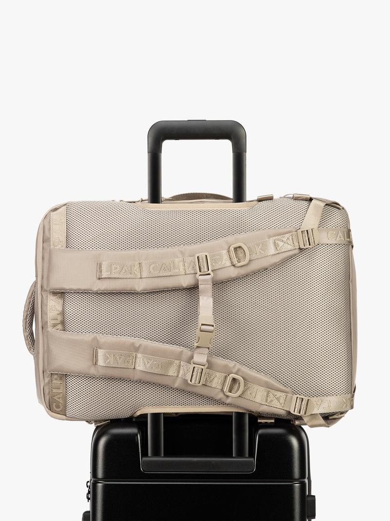 Back trolley sleeve of CALPAK Terra 35L Laptop Backpack Duffel in beige Stone on a white background