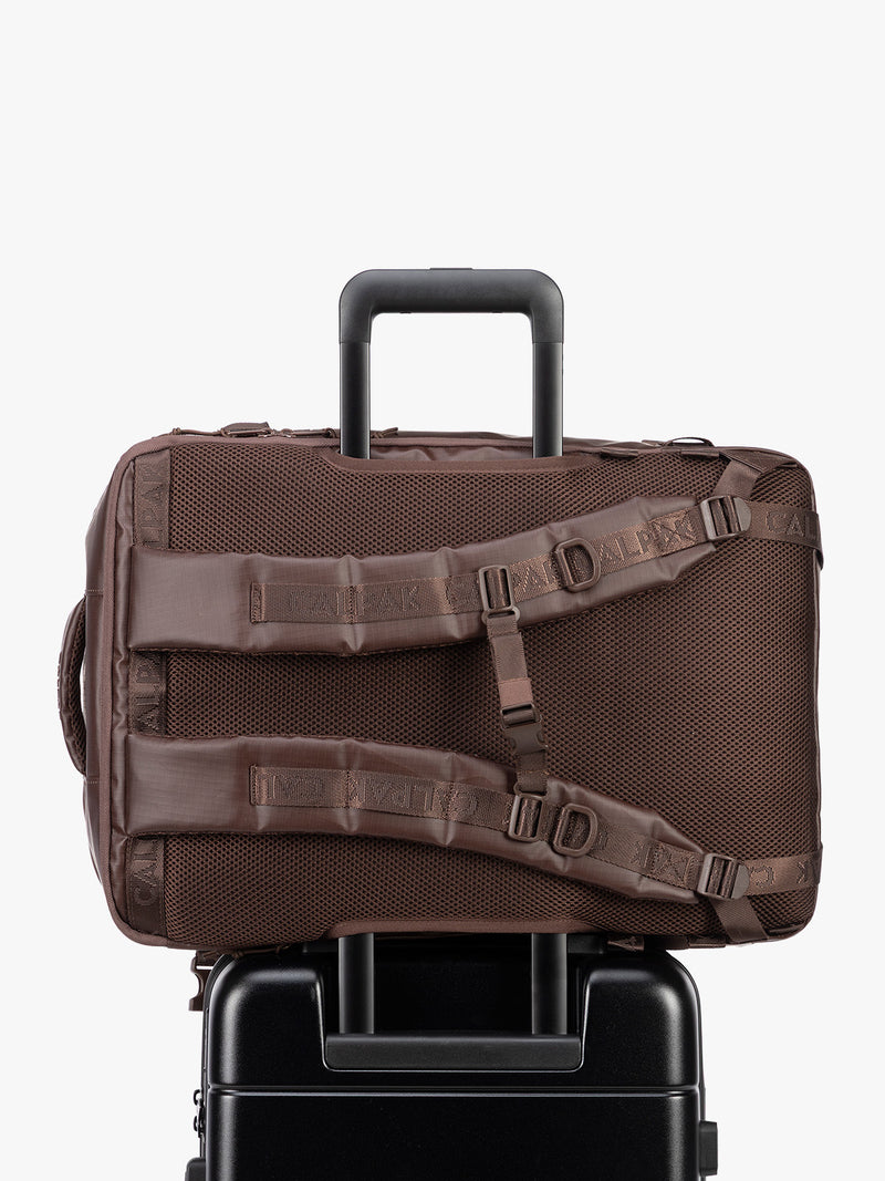 Back trolley sleeve of CALPAK Terra 35L Laptop Backpack Duffel in matte brown Walnut on a white background