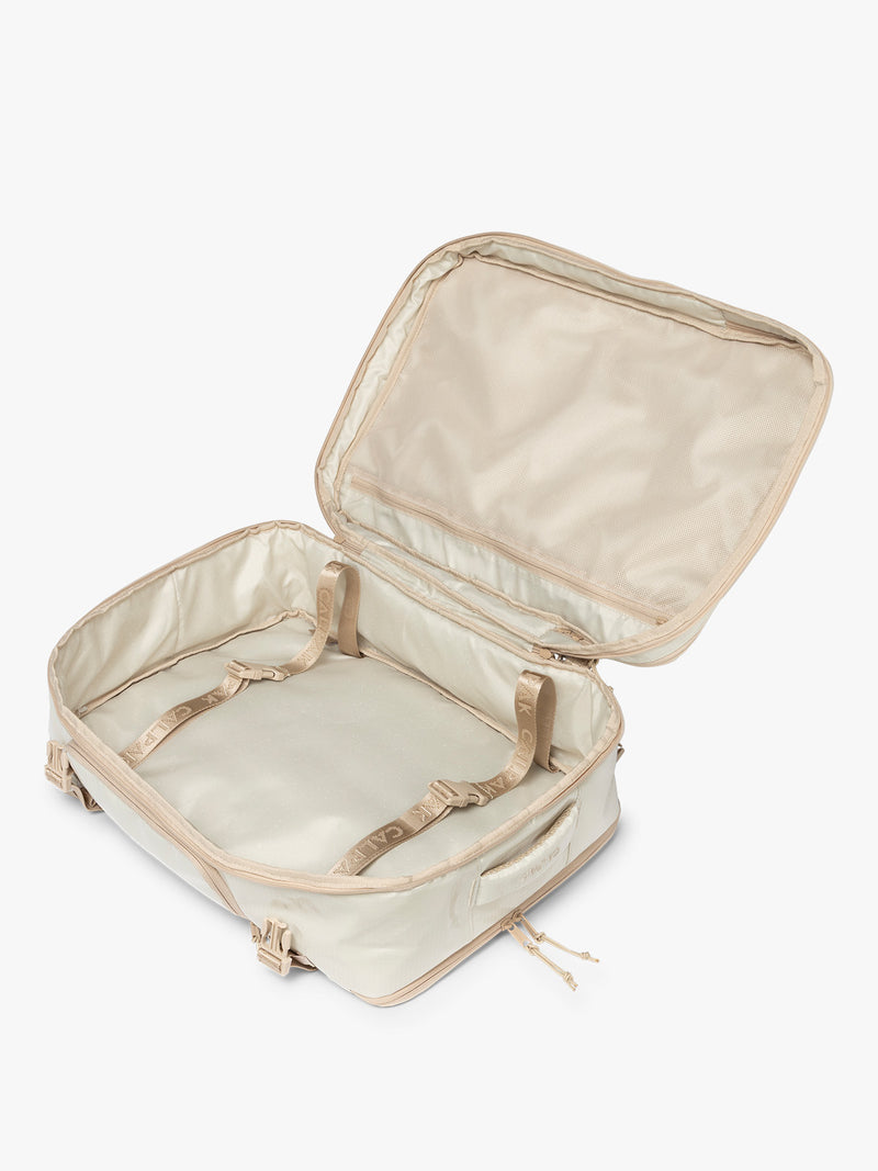 Opened CALPAK Terra 35L Laptop Backpack Duffel in off-white White Sands with tan accents on a white background