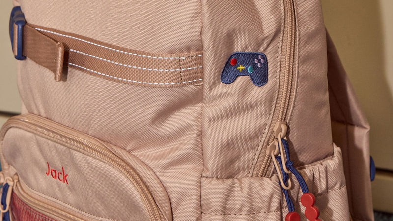 CALPAK Kids Backpack in brown/tan Khaki with a game controller Kids Patch and Embroidery with name reading "Jack" made through personalization