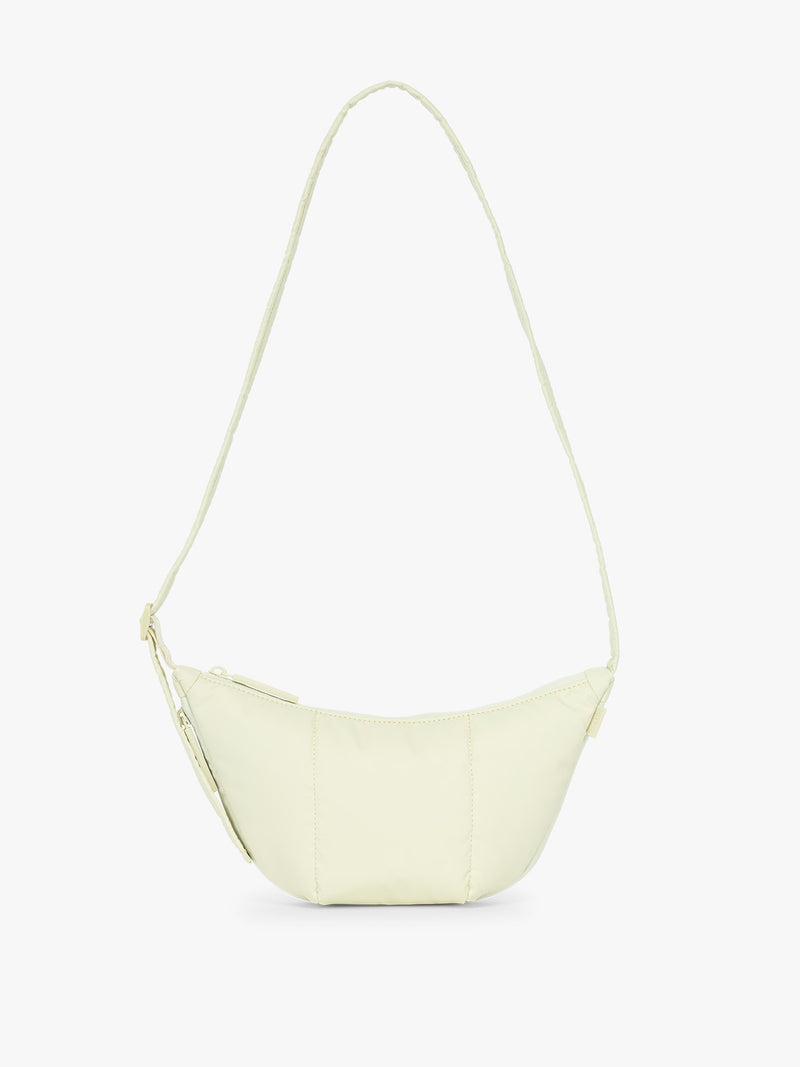 CALPAK Luka Crescent Tote bag in light green Celadon with shoulder strap and bag is expandable up to 2" on a white background