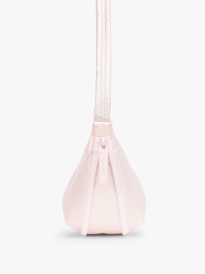 Side expandable zipper of CALPAK Luka Crescent Bag in light pink shiny Pearlescent