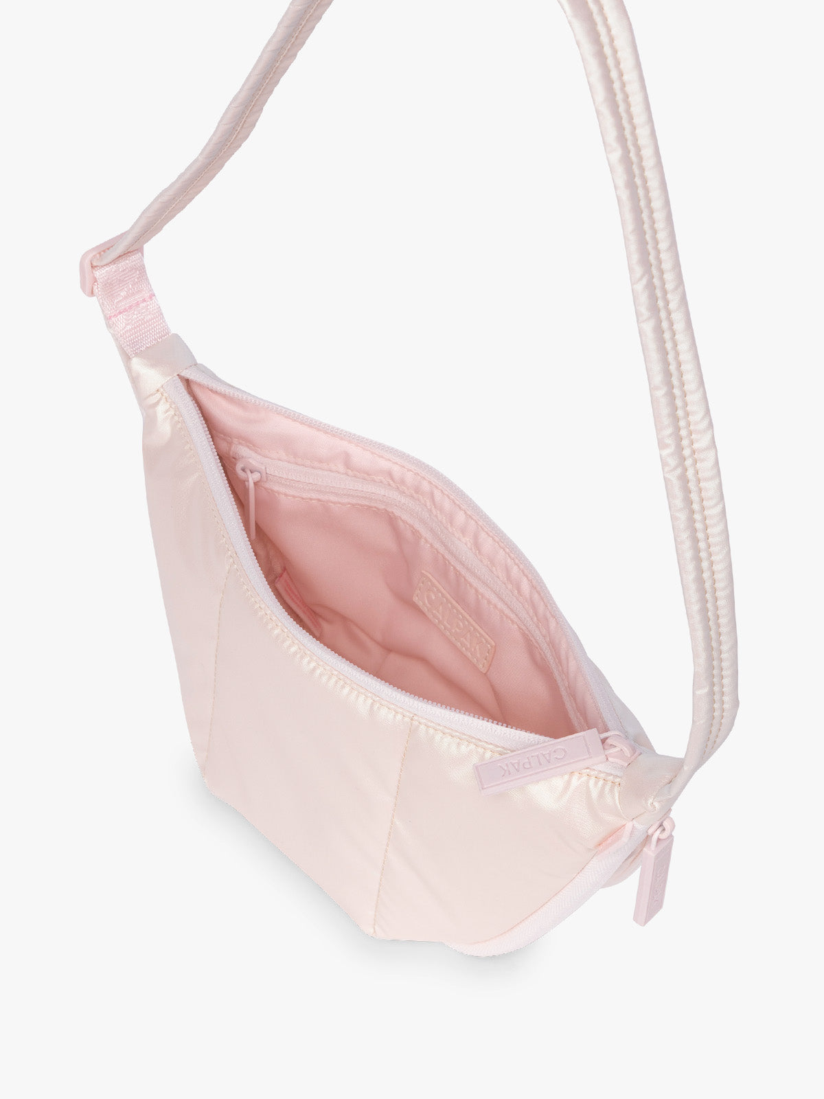 Opened CALPAK Luka Crescent Bag in light pink shiny Pearlescent; CBL2601-PEARLESCENT