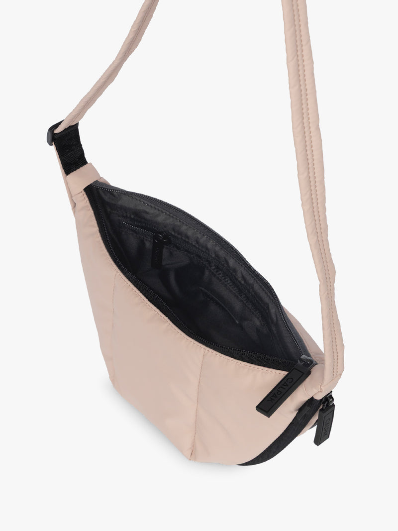 Opened CALPAK Luka Crescent Bag in light pink Rose Quartz