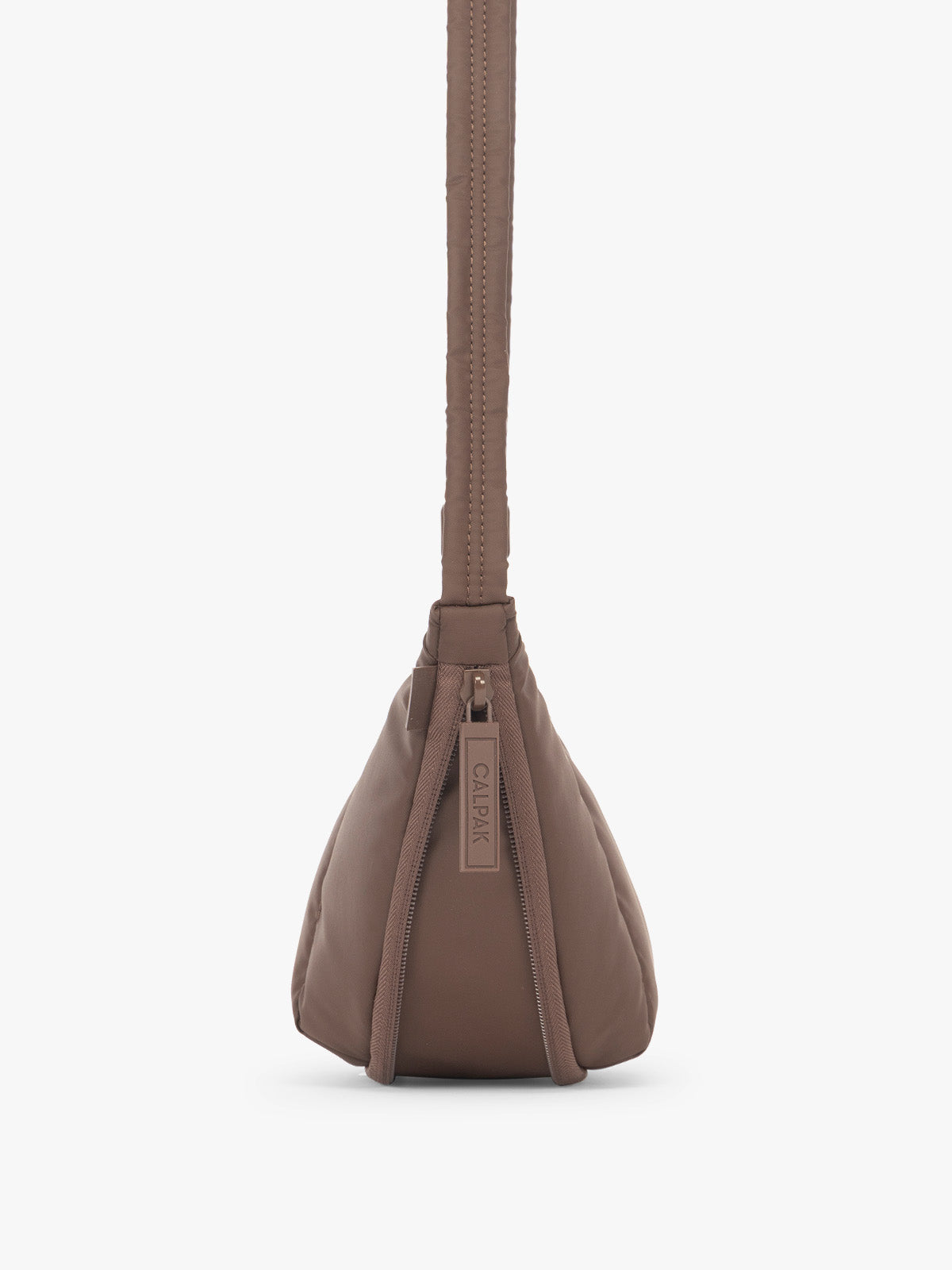 Side view showing function of 2" expandable feature of the CALPAK Luka Crescent Tote bag in brown Walnut with shoulder strap and bag is expandable up to 2"; CBL2601-WALNUT