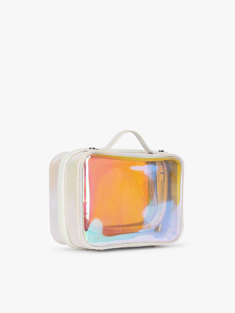 Side view of the Person wearing beige holding a CALPAK Small Clear Cosmetic Case in Moonbeam with white border and transparent holographic iridescent makeup bag with orange on a white background