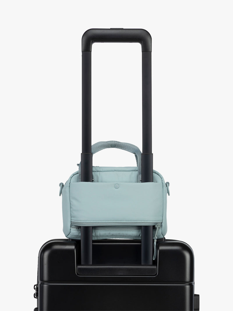 CALPAK Connect Crossbody Bag with trolley sleeve in light blue Bluebell