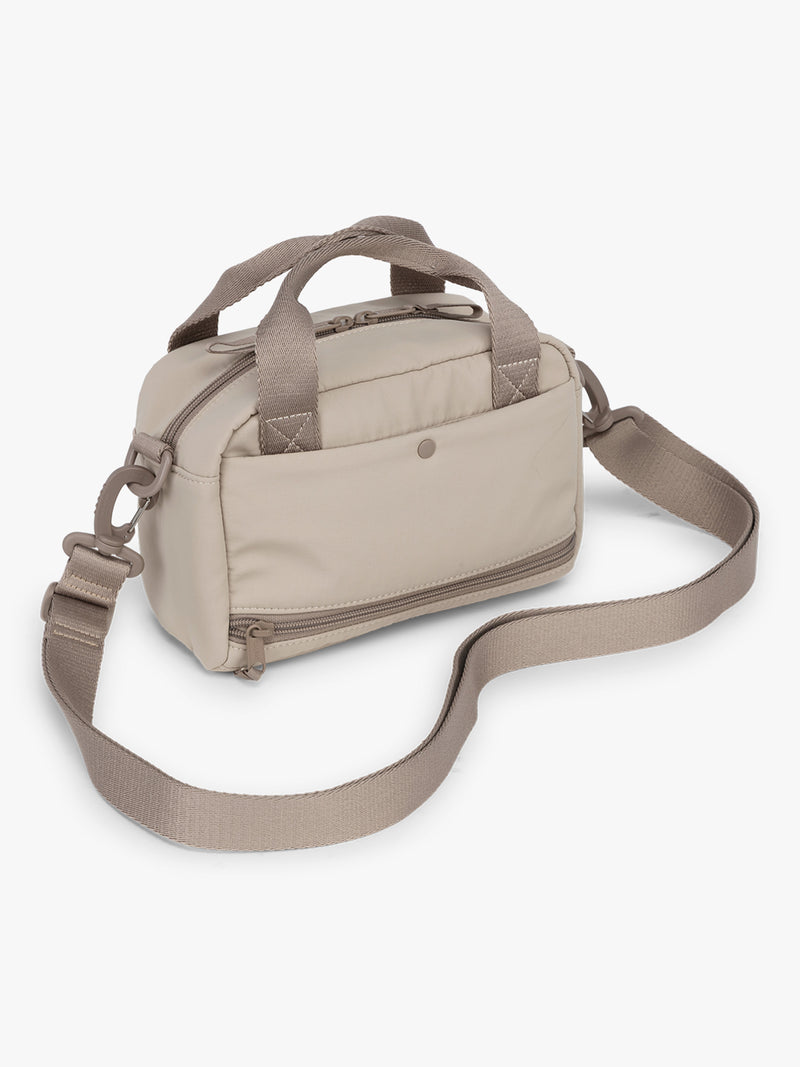 CALPAK Connect Crossbody Bag in beige color Greige with a shoulder strap on a white background