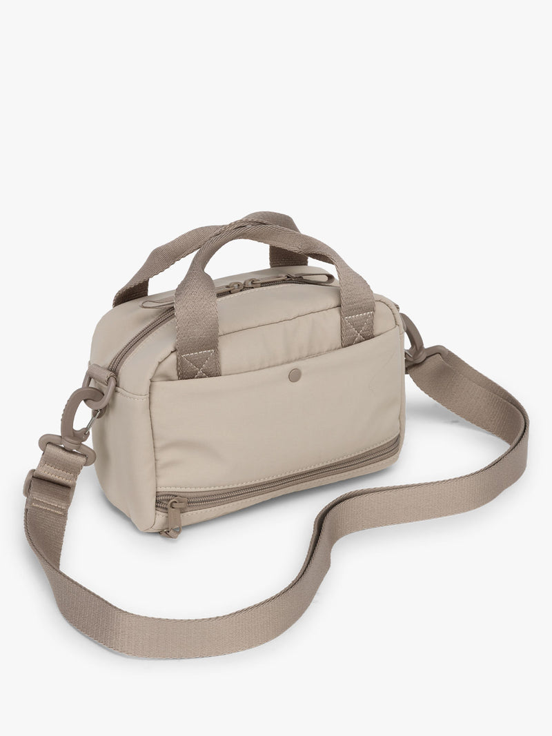 CALPAK Connect Crossbody Bag in beige color Greige with a shoulder strap on a white background