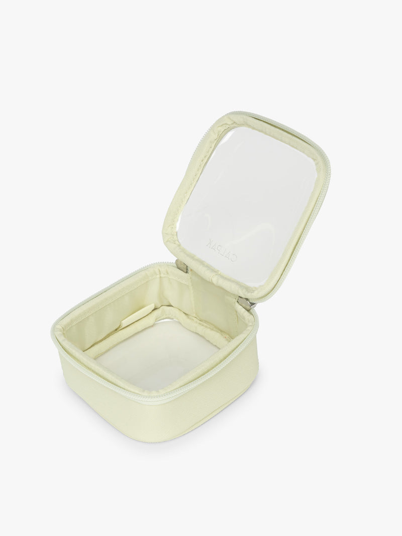 Opened view of CALPAK Tiny Clear Cosmetic Case in light green Celadon