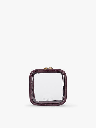 CALPAK Tiny Clear Cosmetics Case that is a transparent pouch with a deep red Dark Cherry in crocodile-embossed; CCT2501-DARK-CHERRY-FAUX-CROC view 1