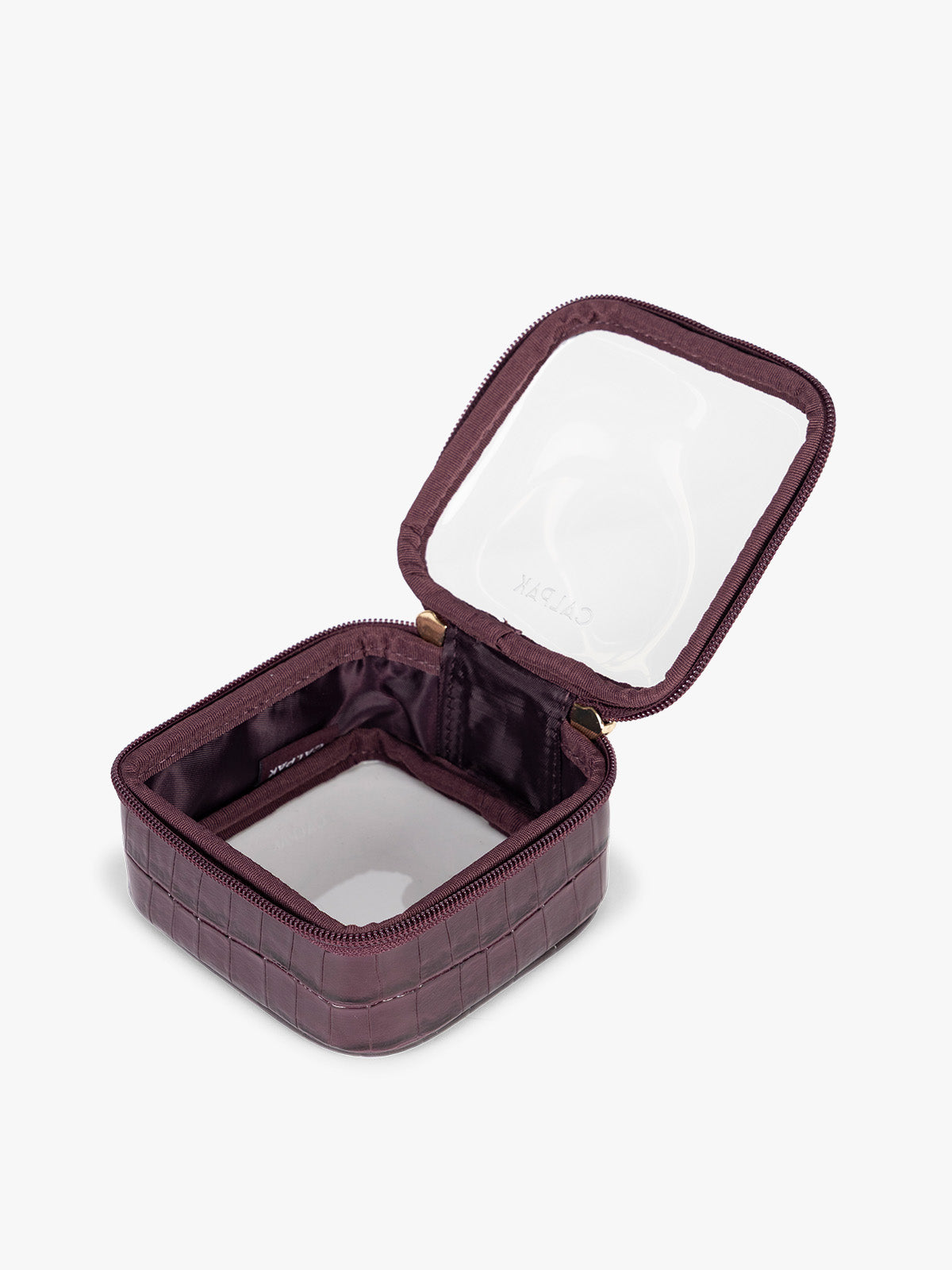 Opened CALPAK Tiny Clear Cosmetics Case that is a transparent pouch with a deep red Dark Cherry in crocodile-embossed; CCT2501-DARK-CHERRY-FAUX-CROC