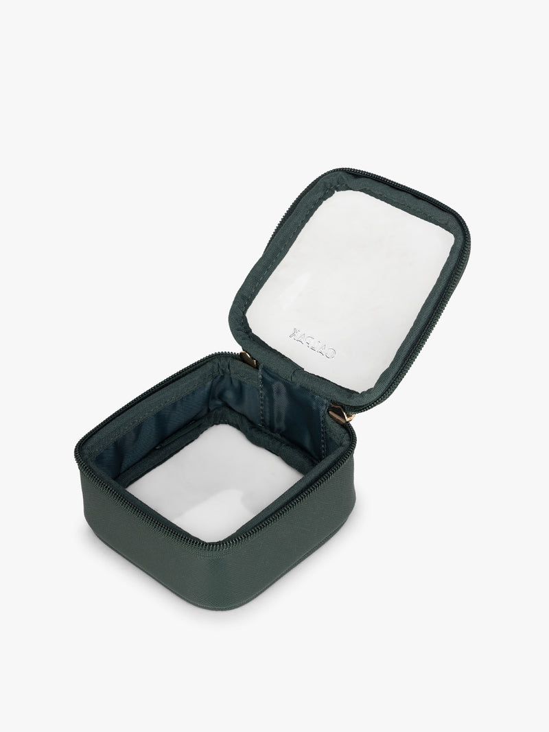 Opened view of CALPAK Tiny Clear Cosmetics Case in dark green Emerald on a white background