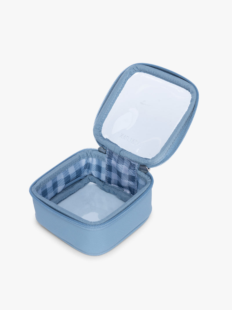 Opened view of CALPAK Clear Cosmetic Case in light blue Metallic Indigo