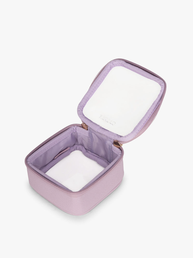 Opened view of CALPAK Tiny Clear Cosmetics Case in purple Lavender on a white background