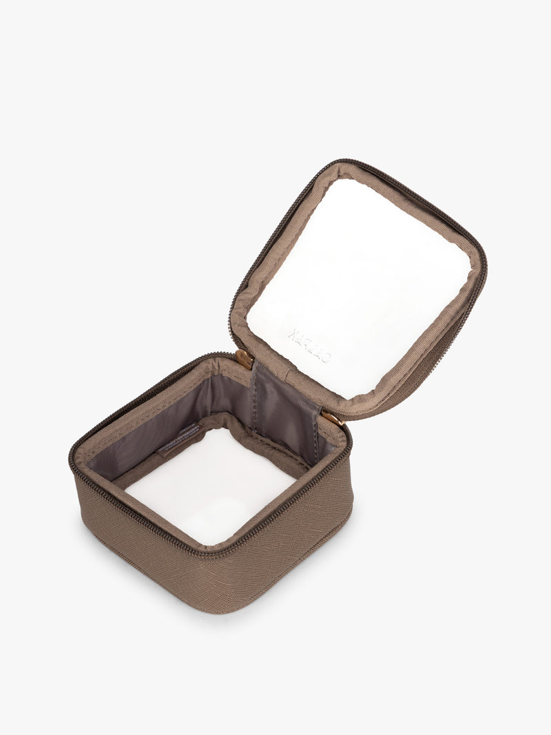 Opened view of CALPAK Tiny Clear Cosmetics Case in brown Mocha on a white background