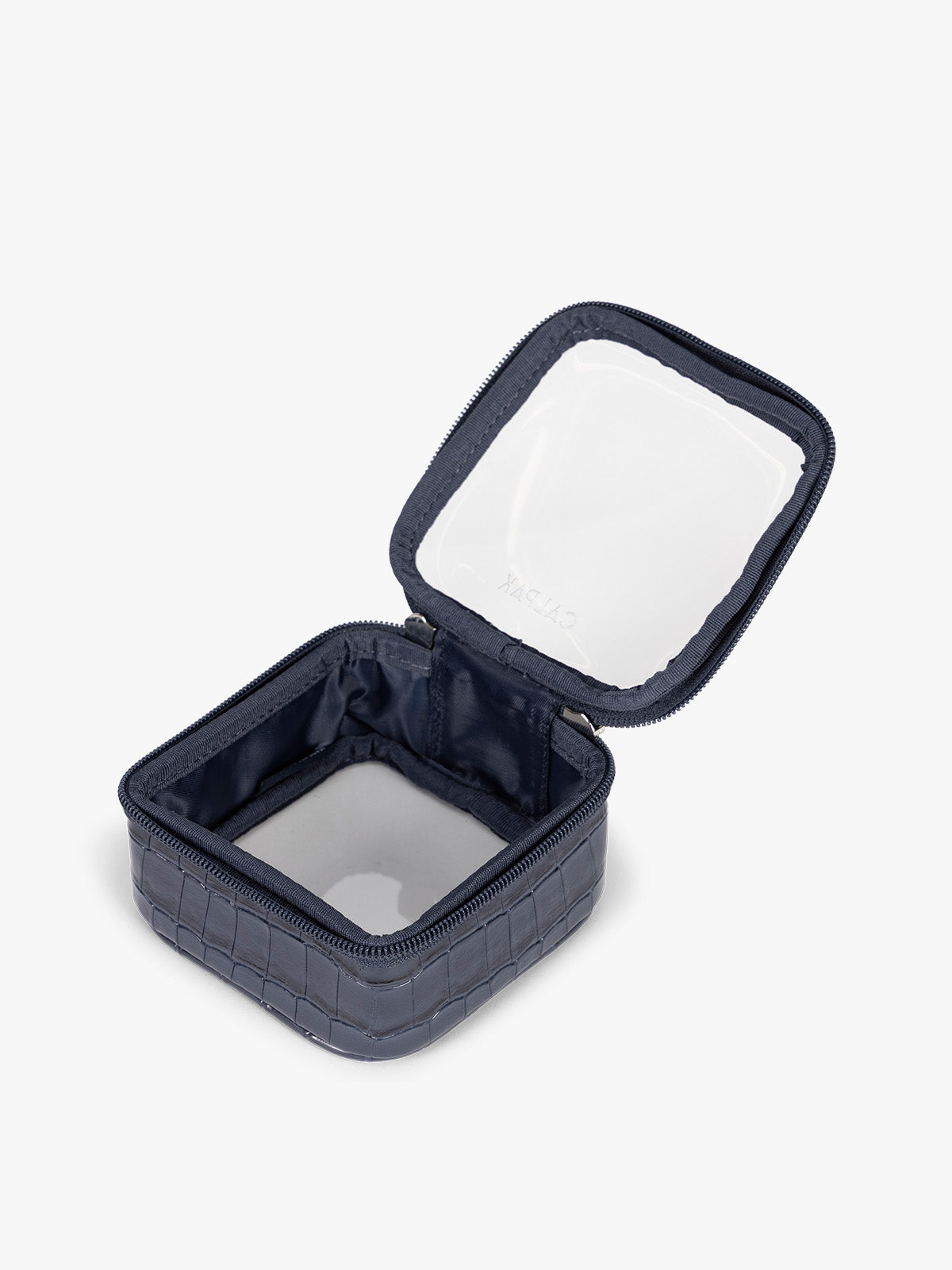 Opened CALPAK Tiny Clear Cosmetics Case that is a transparent pouch with a dark navy blue in crocodile-embossed; CCT2501-NAVY-FAUX-CROC