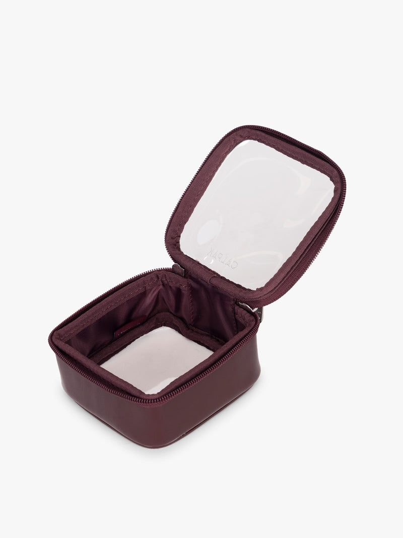 Opened view of CALPAK Tiny Clear Cosmetics Case in maroon Dark Cherry