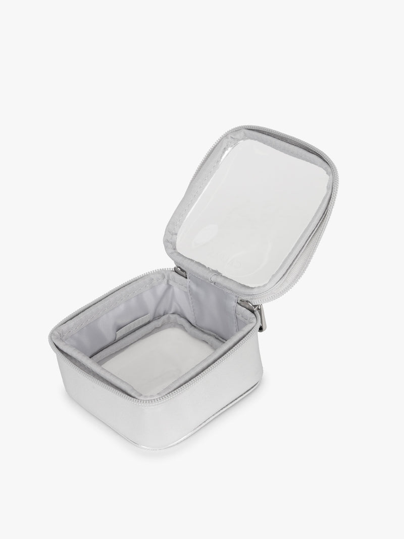 Opened view of CALPAK Tiny Clear Cosmetics Case in Silver