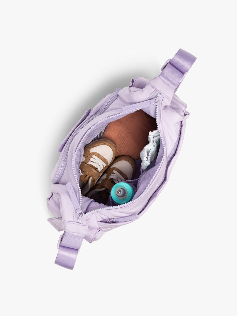 CALPAK Crossbody Diaper Bag in light purple Orchid top view with zipper opened, showing interior of bag