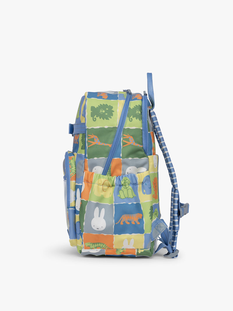 Side view of CALPAK Kids Large Backpack with Miffy and blue colorful animal pattern on a white background