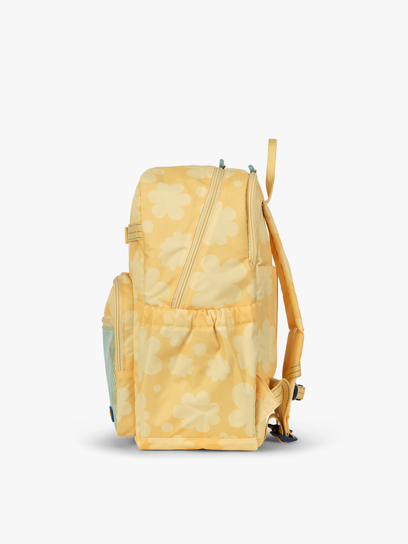 CALPAK Kids Large Backpack in yellow with tan flower print in Yellow Bloom side view with water bottle holder pocket