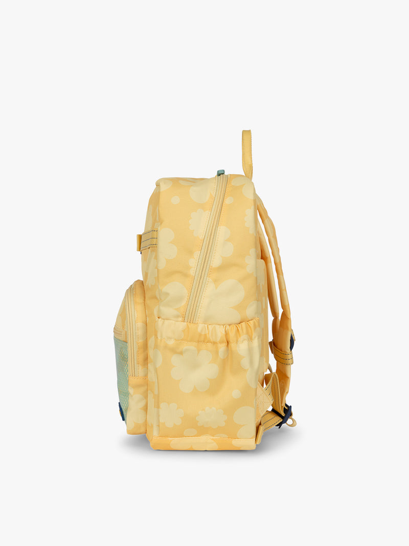 CALPAK Kids Medium Backpack in yellow with tan flower print in Yellow Bloom for ages 5-8 side view with water bottle holder pocket
