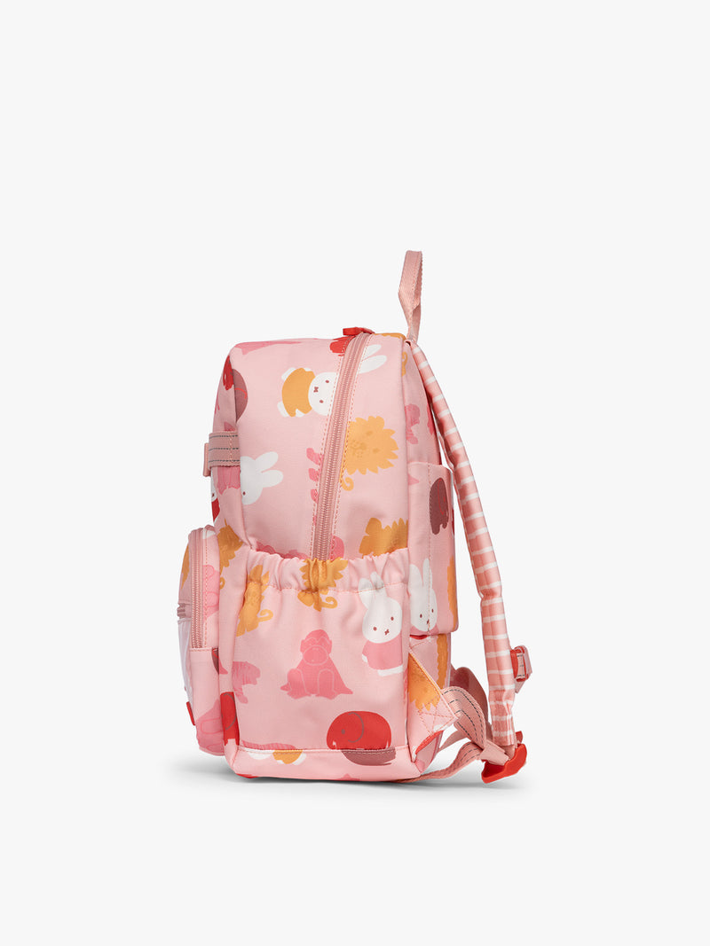 Side view of CALPAK Kids Small Backpack with Miffy and pink colorful animal pattern on a white background