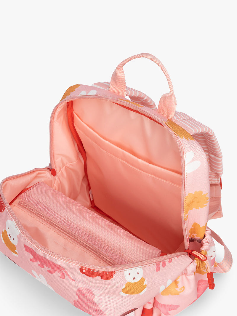 Opened view of CALPAK Kids Small Backpack with Miffy and pink colorful animal pattern on a white background