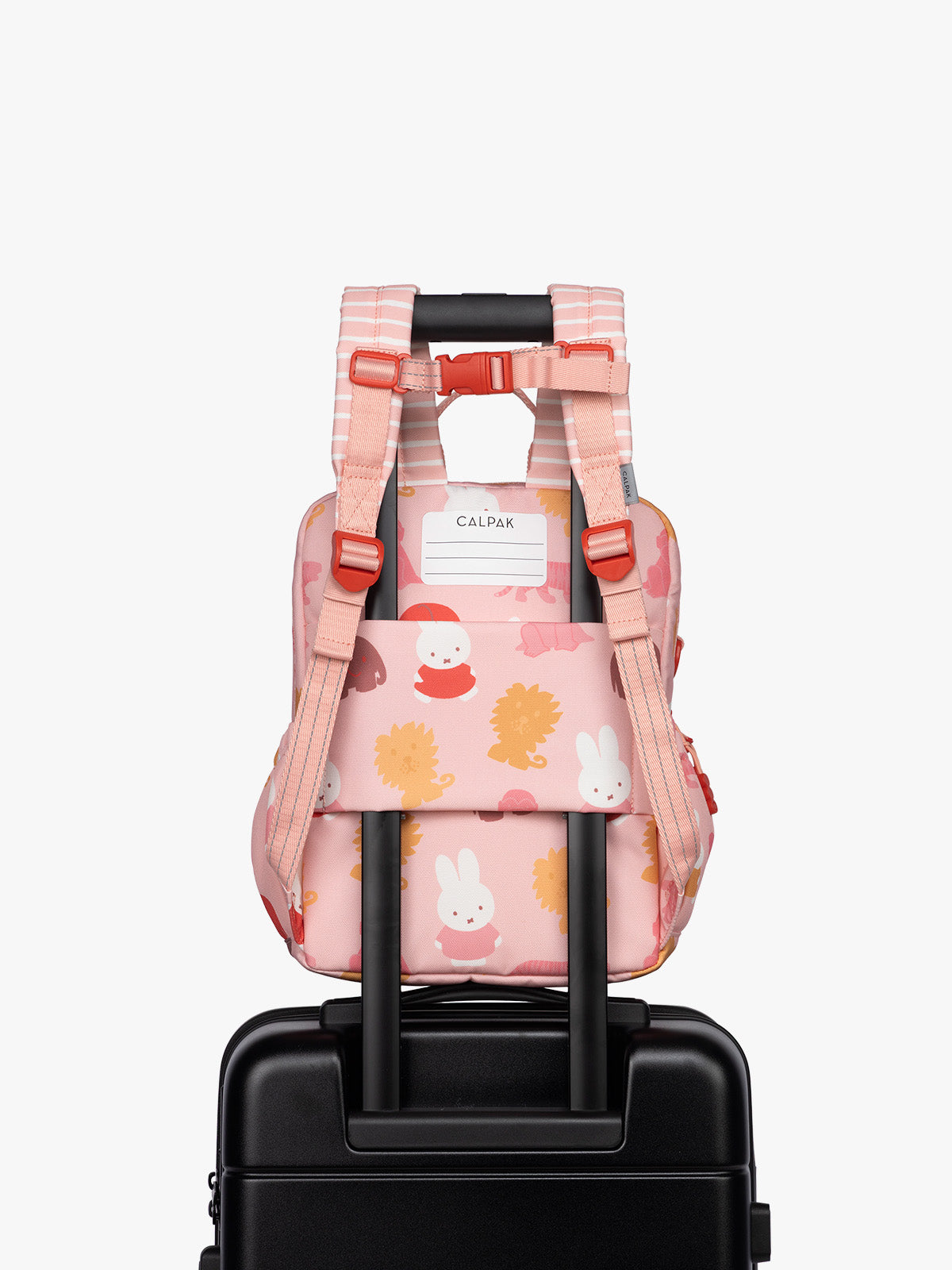 Back luggage trolley sleeve of CALPAK Kids Small Backpack with Miffy and pink colorful animal pattern on a white background; CKBS2501-MIFFY-PINK-ZOO-TRIP