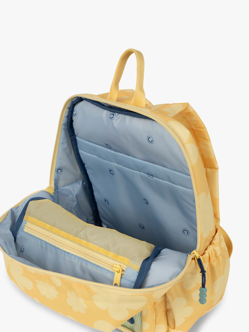 CALPAK Kids Small Backpack in yellow with tan flower print in Yellow Bloom for ages 3-5 opened view with multiple interior pockets and blue lining