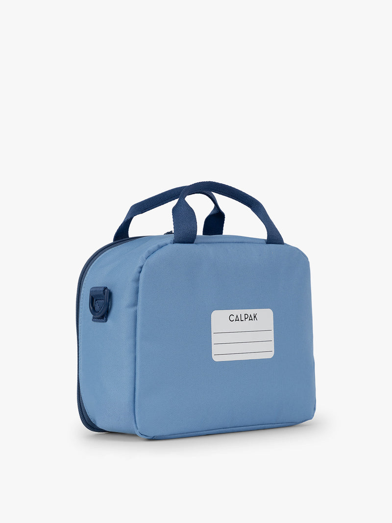 CALPAK Kids Lunch Bag in Blue back view with top handle and name tag section