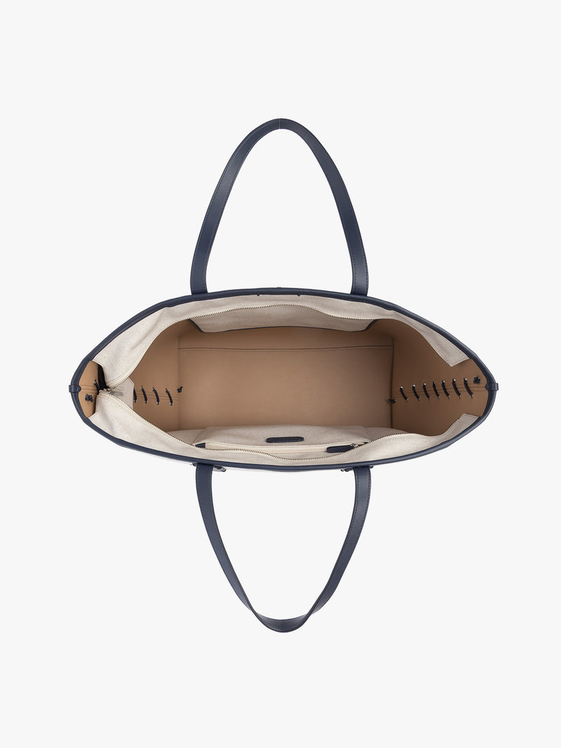 Opened CALPAK Colette 15" Canvas Laptop Tote with zipper in beige canvas material  with blue finishing in Natural Navy