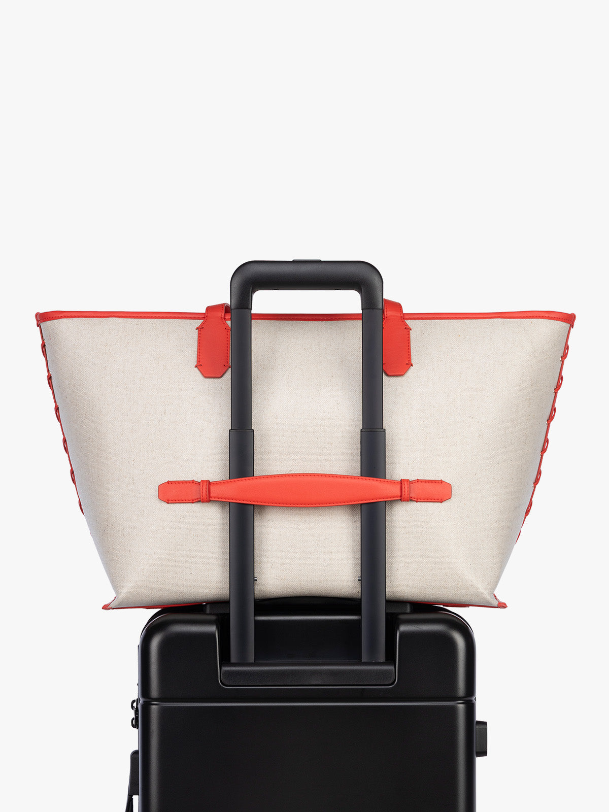 Trolley sleeve of CALPAK Colette 15" Canvas Laptop Tote in beige canvas material  with red finishing in Natural Tomato; CLCT2601-NATURAL-TOMATO