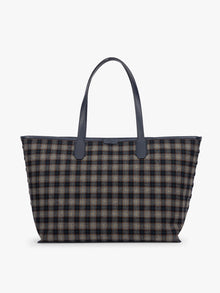 A CALPAK Colette 15" Laptop tote bag with a brown and navy blue plaid pattern and dark navy blue handles, shown against a plain white background; CLCT2601-NAVY-PLAID