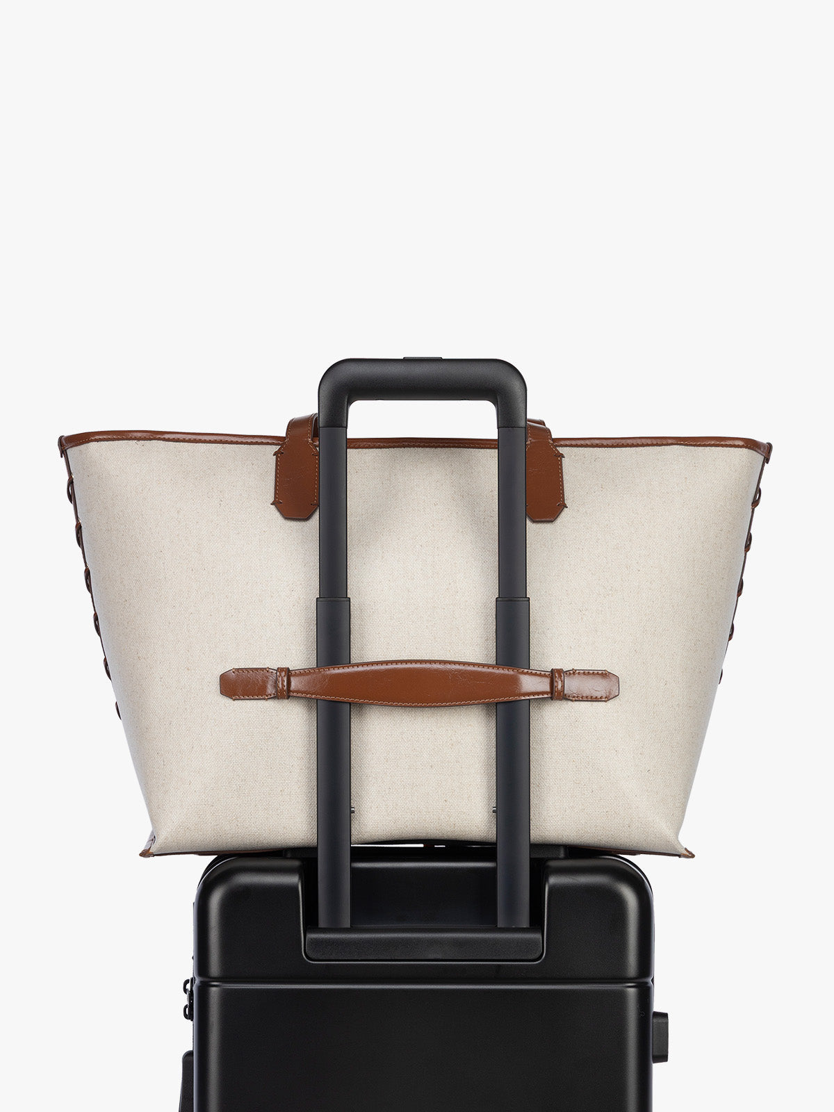 Trolley sleeve of CALPAK Colette 15" Canvas Laptop Tote in beige canvas material  with brown finishing in Natural Brown; CLCT2601-NATURAL-BROWN