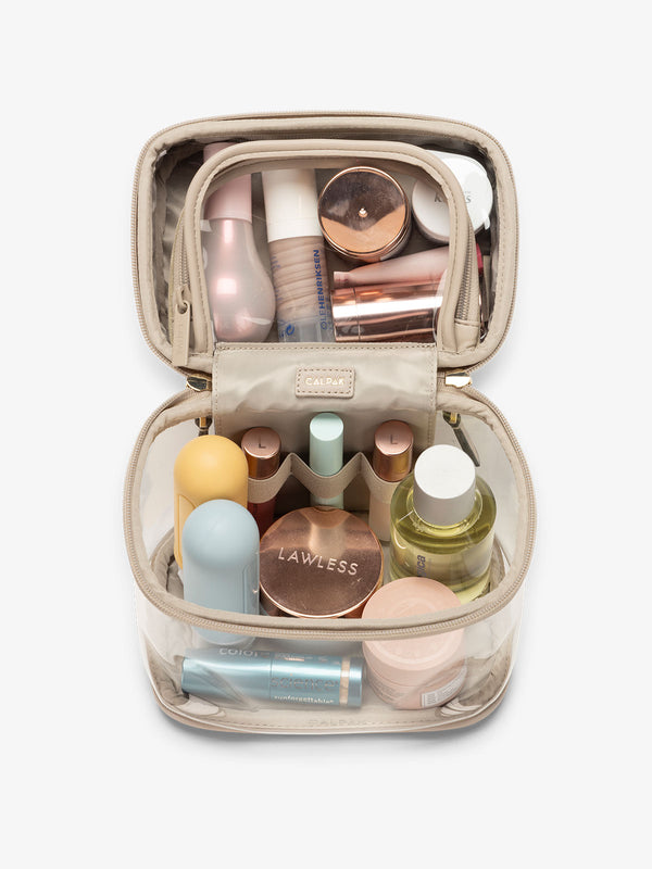 clear train case with top interior pocket for makeup and cosmetics in stone beige