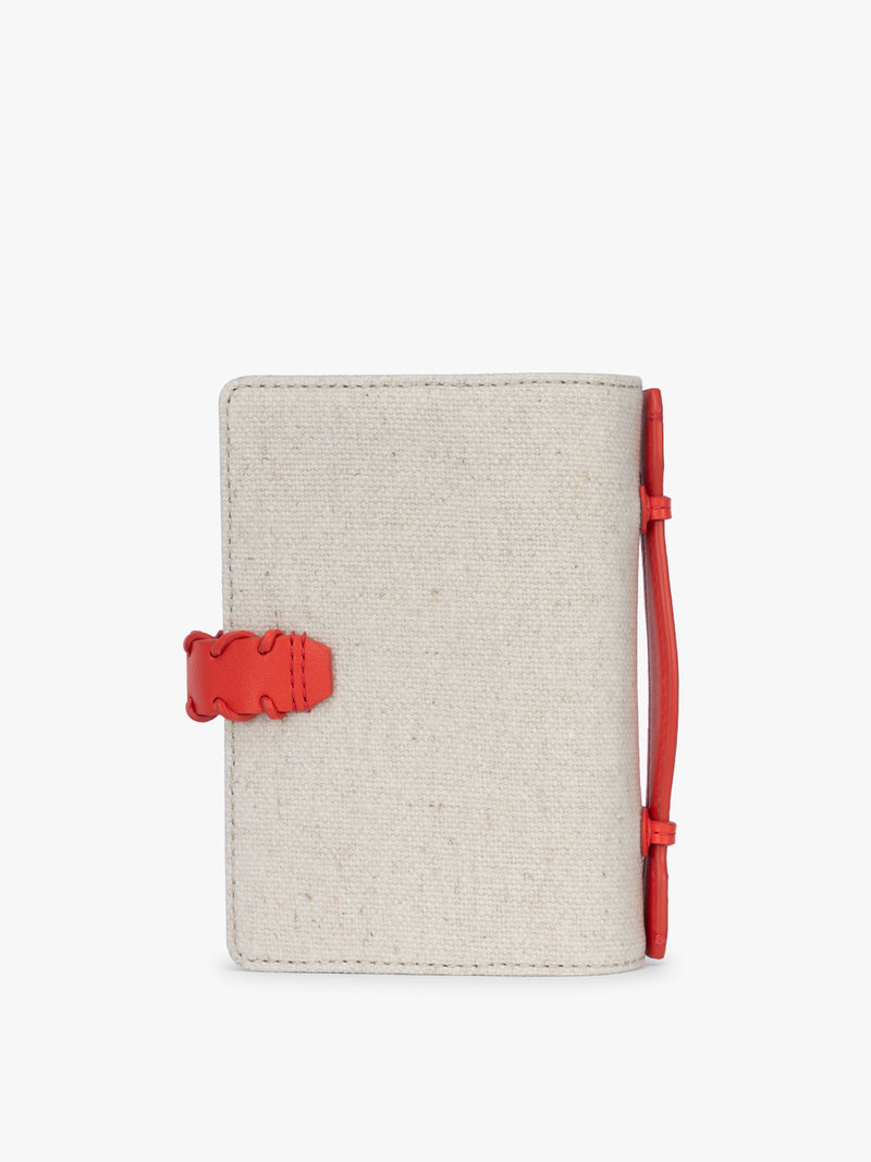 Backside of CALPAK Colette Multi Passport Wallet in beige canvas material and red finishings in Natural Tomato