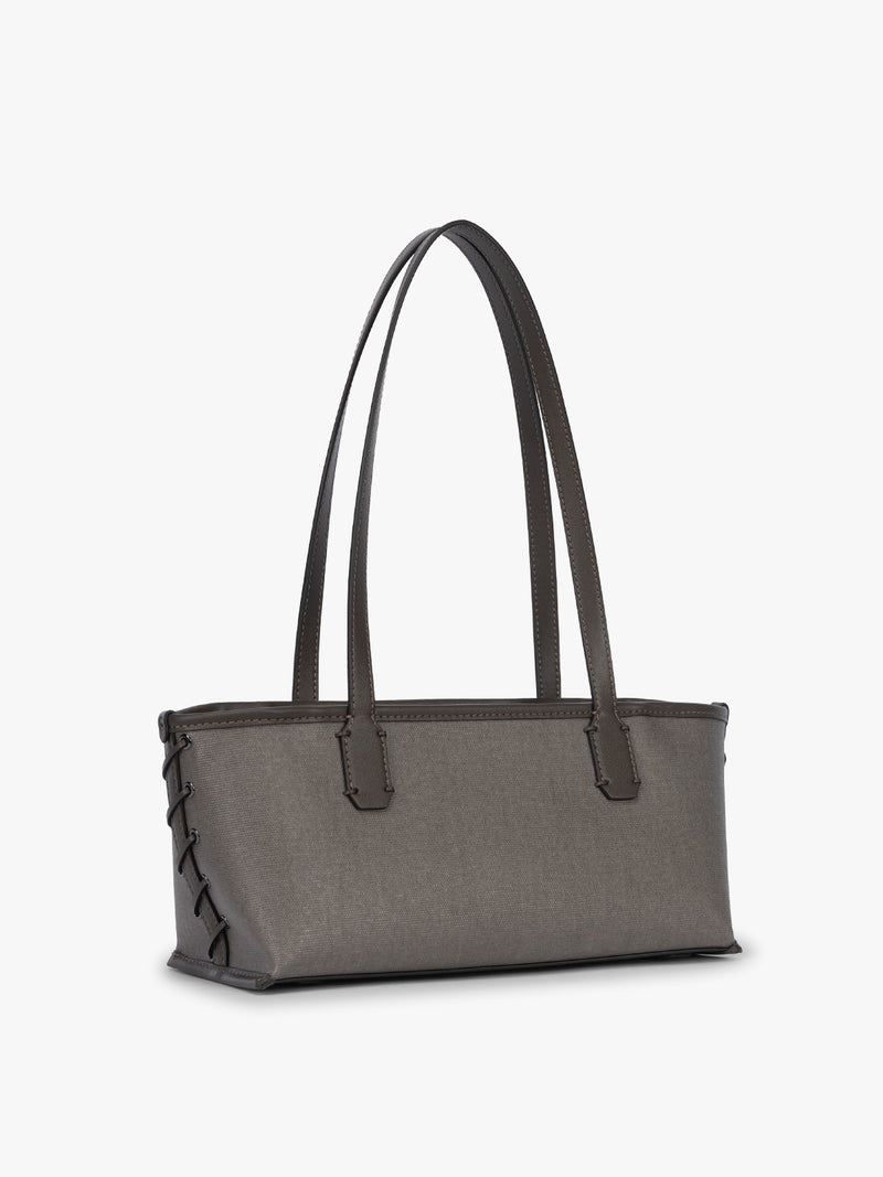 Side view and stitching of CALPAK Colette Canvas Shoulder Tote in brown Mushroom canvas material and side hand-finished stitch