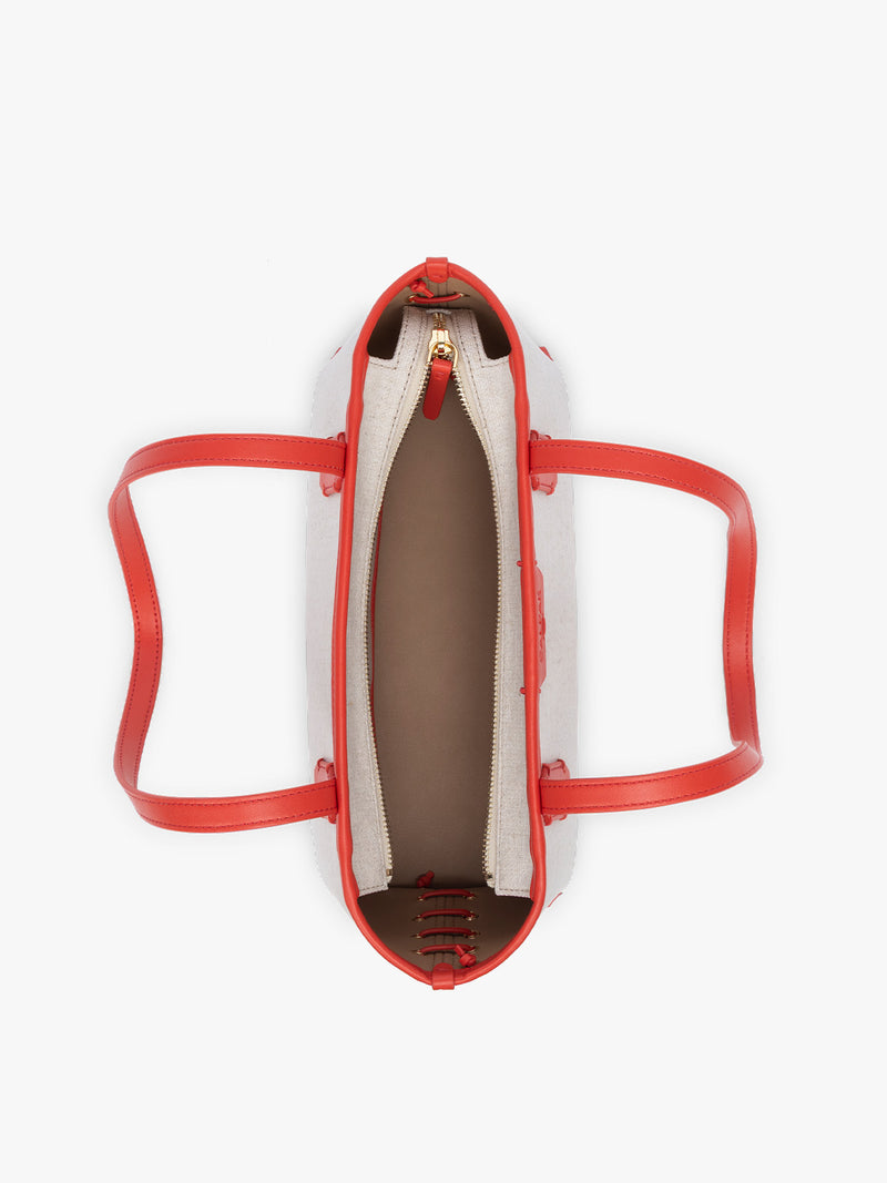 Top view of CALPAK Colette Canvas Shoulder Tote with zipper in beige canvas material  and red finishing