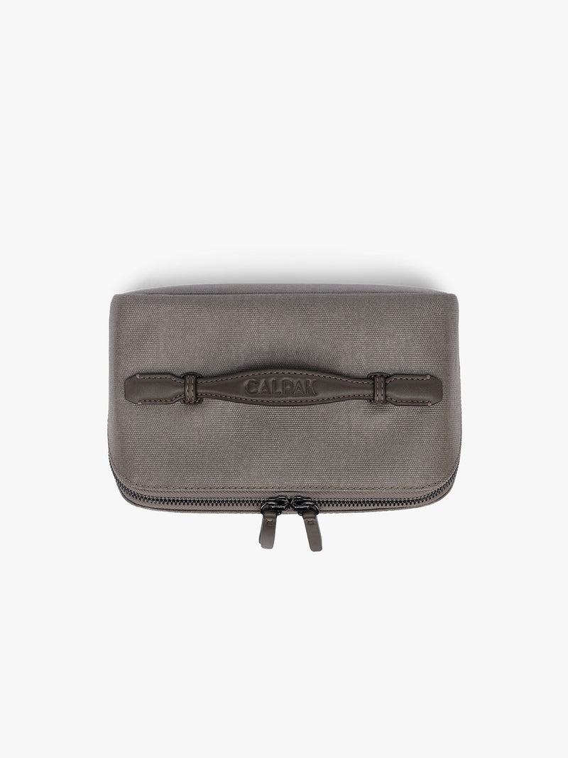 Top view of CALPAK Colette Lay-Flat Canvas Toiletry Bag in brown Mushroom canvas material