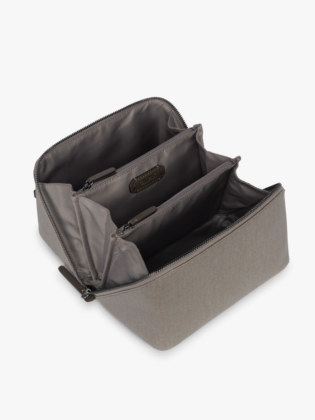 Opened CALPAK Colette Lay-Flat Canvas Toiletry Bag in brown Mushroom canvas material laying flat open; CLTB2601-MUSHROOM