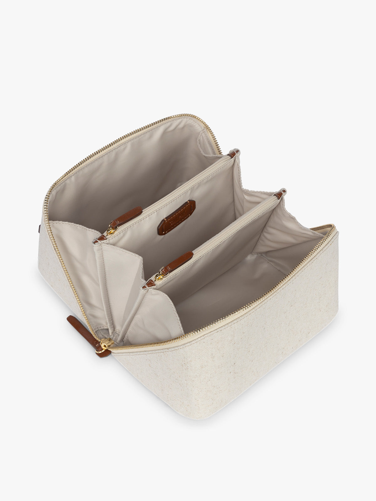 Opened CALPAK Colette Lay-Flat Canvas Toiletry Bag in beige canvas  material and brown finishing; CLTB2601-NATURAL-BROWN