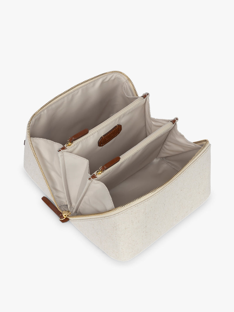 Opened CALPAK Colette Lay-Flat Canvas Toiletry Bag in beige canvas  material and brown finishing
